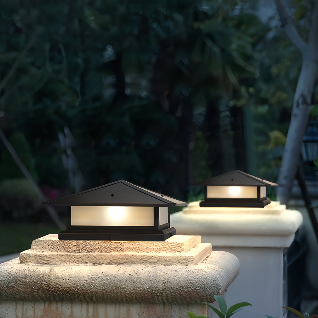 Close-up view of the minimalist house-style black pillar lights fixture isolated on a white background, highlighting its flat-top base.