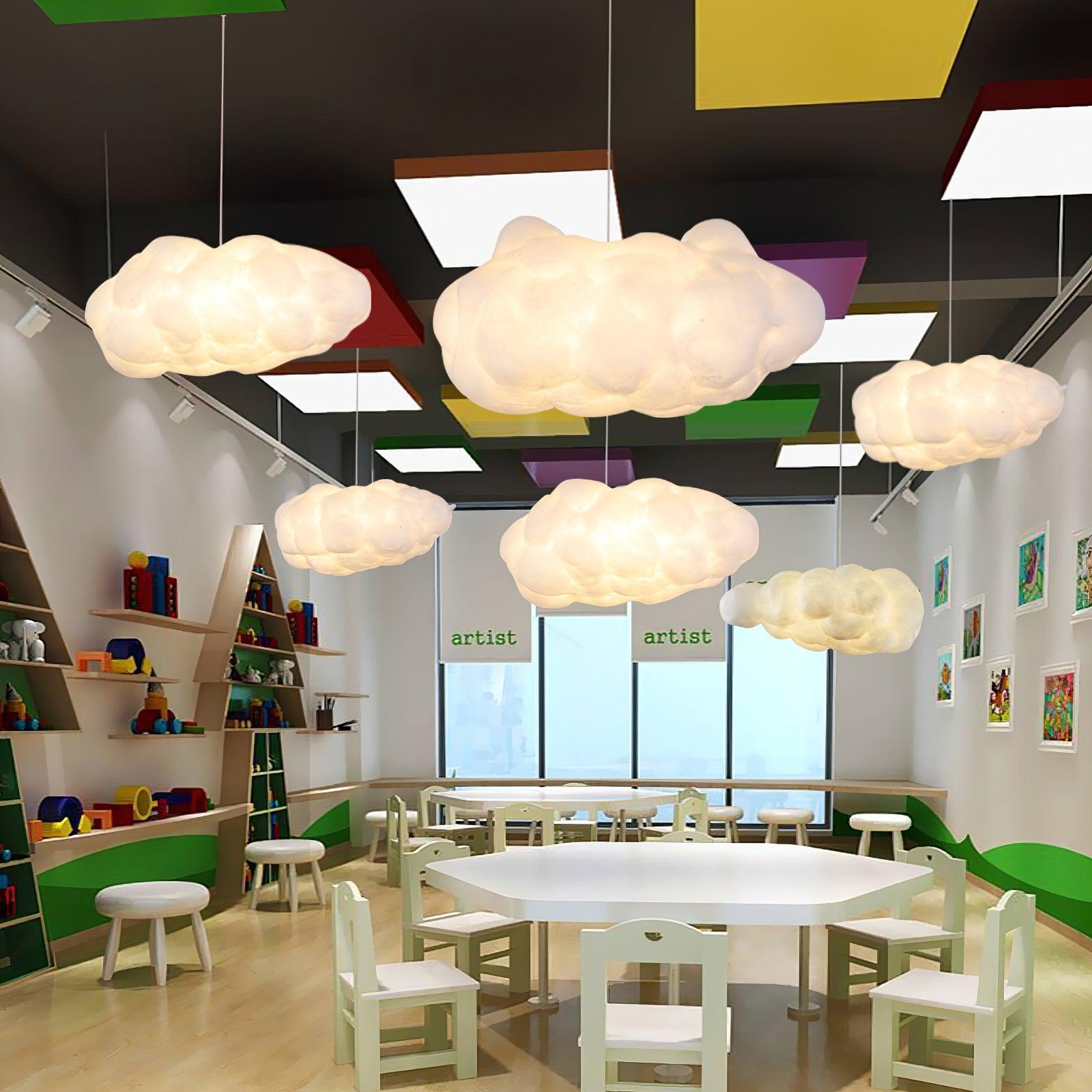 Multiple cloud-shaped pendant lights installed in a colorful children’s activity room ceiling.