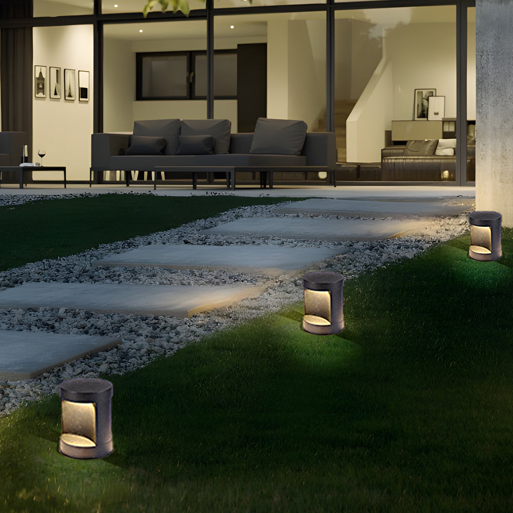 Commercial LED bollard lights illuminating a contemporary building entrance.