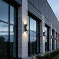 Contemporary commercial exterior illuminated by up down wall light with architectural beam effects.