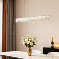 Contemporary chrome chandelier providing elegant focal point lighting above modern dining table.