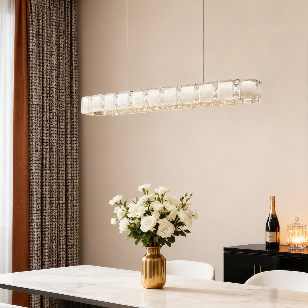 Contemporary chrome chandelier providing elegant focal point lighting above modern dining table.