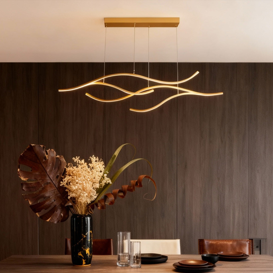 Contemporary curved LED pendant light with warm glow in a modern dining room setting.