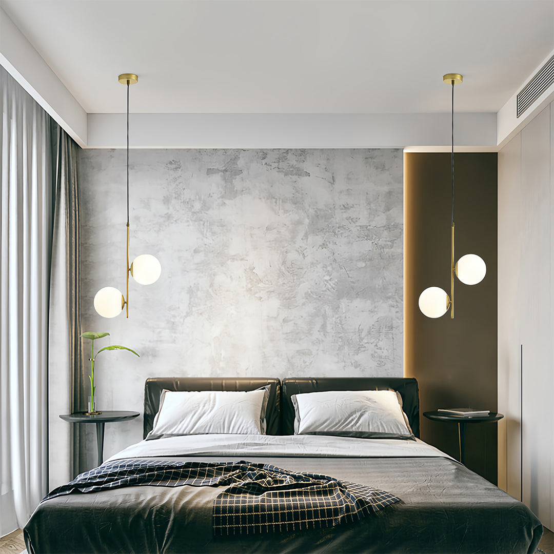 Contemporary glass hanging pendant lights in minimalist space with clean lines and modern architectural details