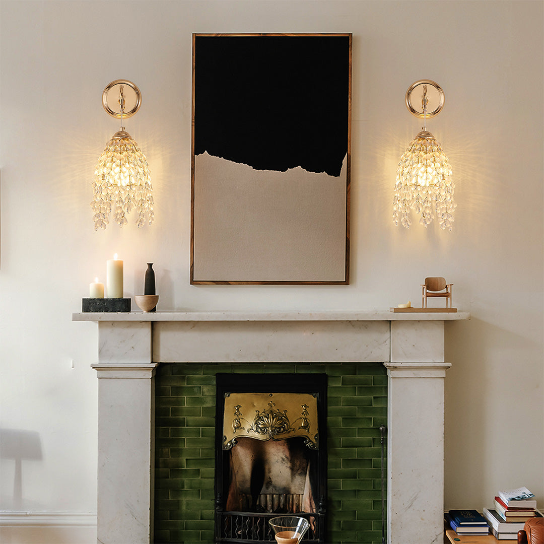 Contemporary LED wall light decor with glass shade chandelier design creating symmetrical lighting beside green tiled fireplace mantel.