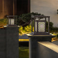 Angled view of contemporary outdoor light showing geometric panel construction and warm glow