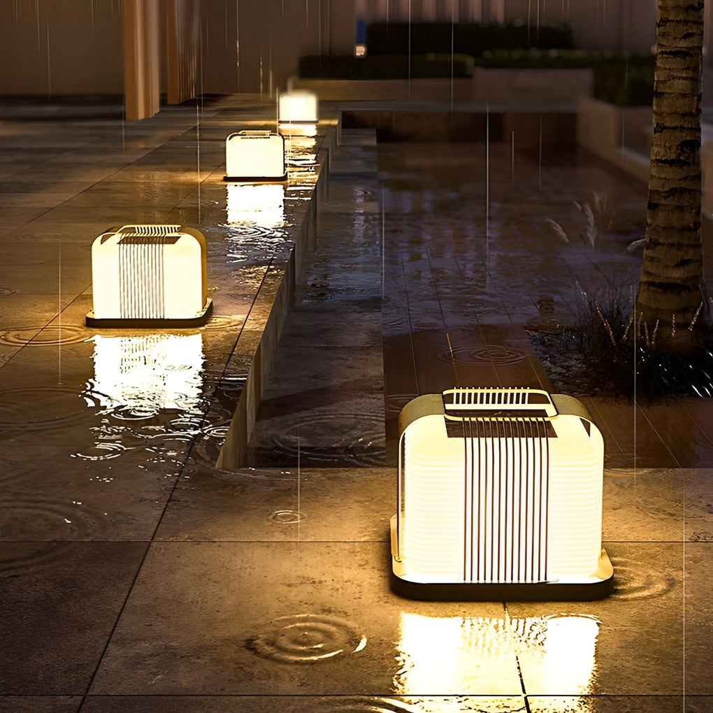 Contemporary outdoor pillar lights with a modern design, enhancing a garden pathway at dusk.