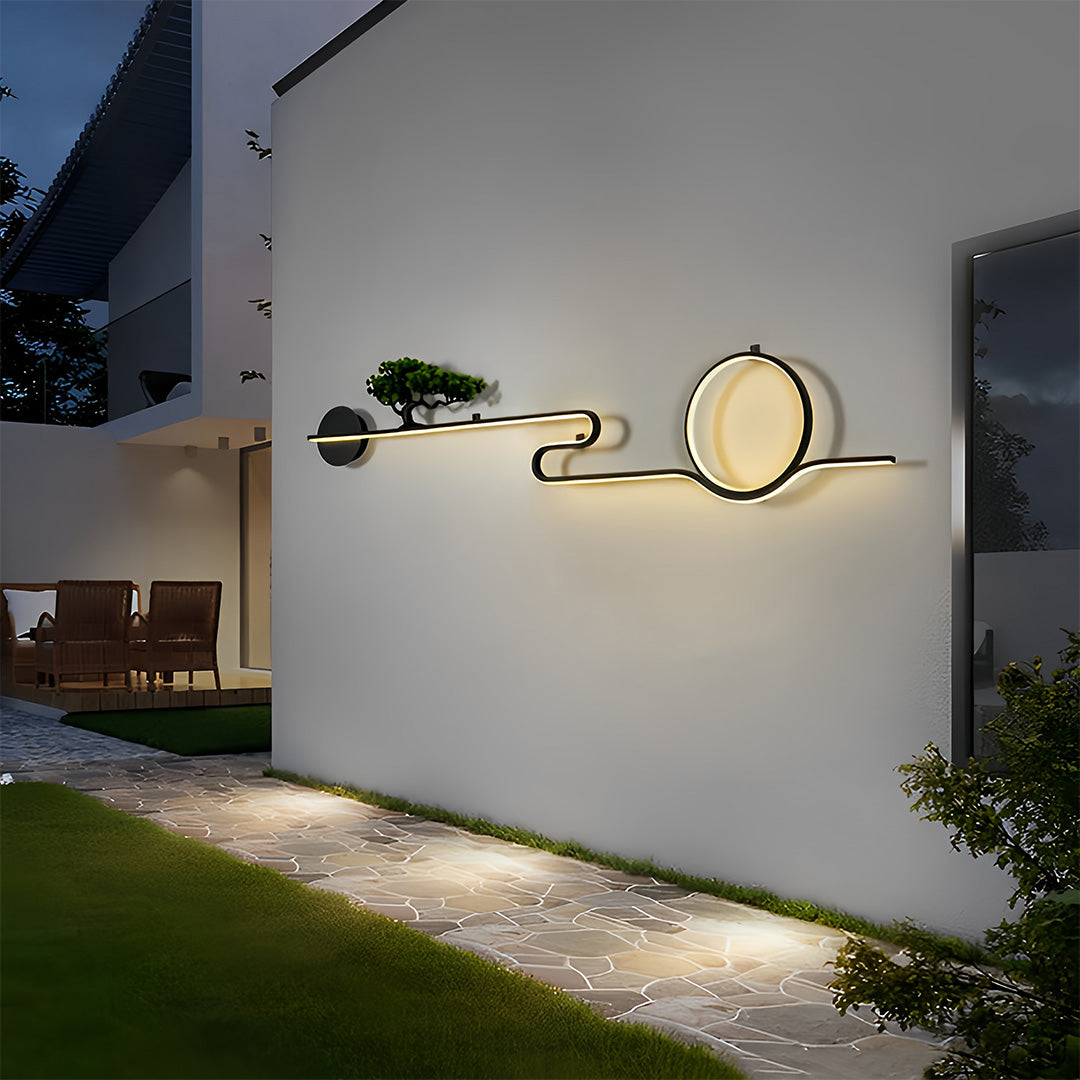 Contemporary outdoor wall lights illuminating a minimalist courtyard exterior wall.
