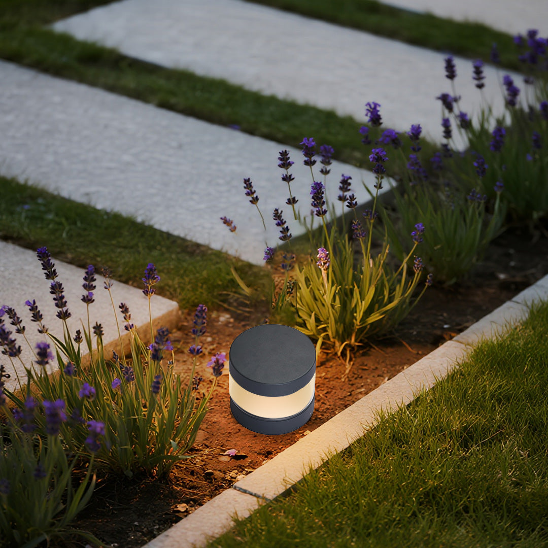 Modern contemporary path lights guiding a paved garden path, blending minimal form with functional outdoor lighting.