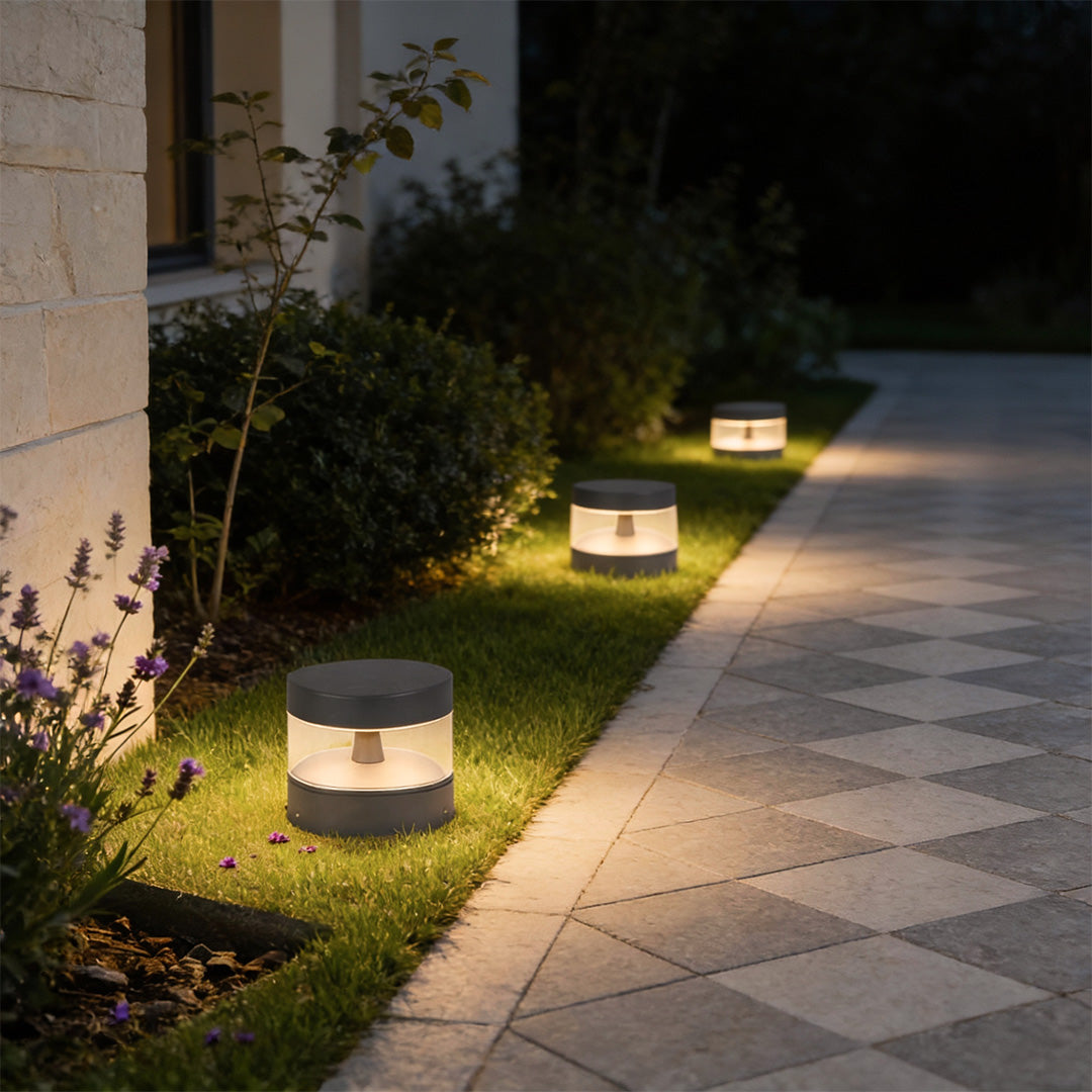 Contemporary path lights lining a residential walkway, offering even light distribution and a clean architectural look.