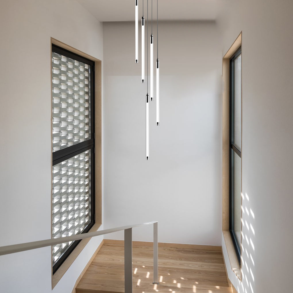 Contemporary staircase chandelier hanging above a glass-railed staircase, adding sophistication.