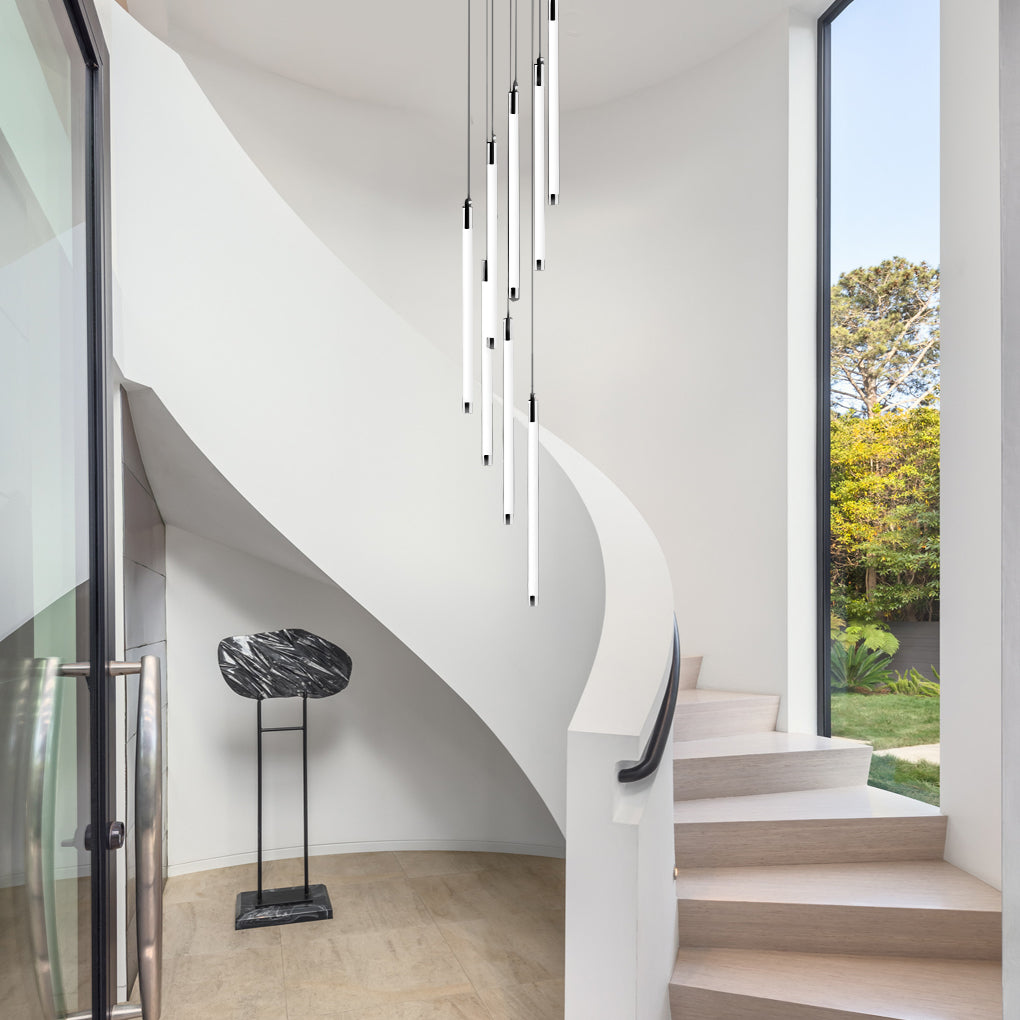 Contemporary staircase chandelier with linear lights, enhancing the openness of a bright staircase.
