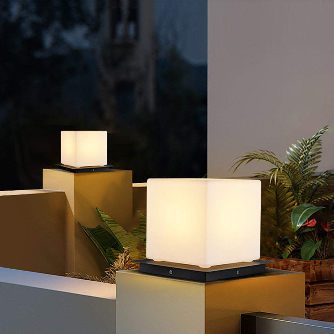 Silver Metal Table Lamp modern pillar lights arranged on contemporary outdoor terrace with sophisticated architectural lighting design