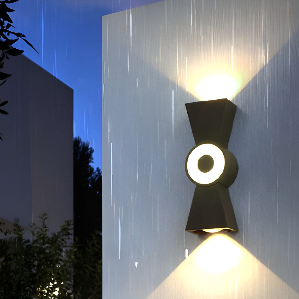 Contemporary up down wall lights enhancing a bedroom with warm, elegant glow.