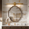 Contemporary vanity light bar with a sleek gold design, illuminating a luxurious bathroom mirror.