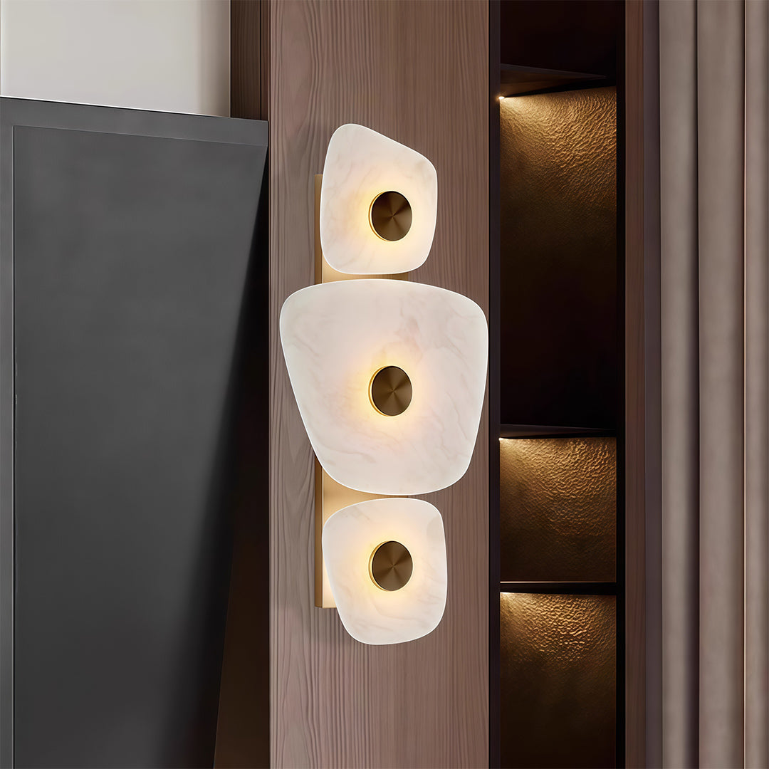 Contemporary wall art lighted with glass shade chandelier styling illuminating modern dark wood door entrance with artistic glow.