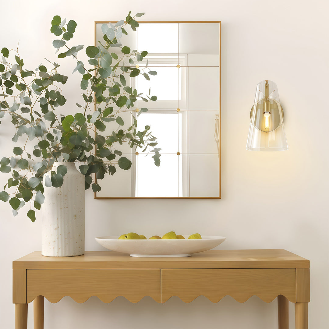 Modern luxury chandeliers inspired contemporary wall sconce lighting above console with plants and artwork.