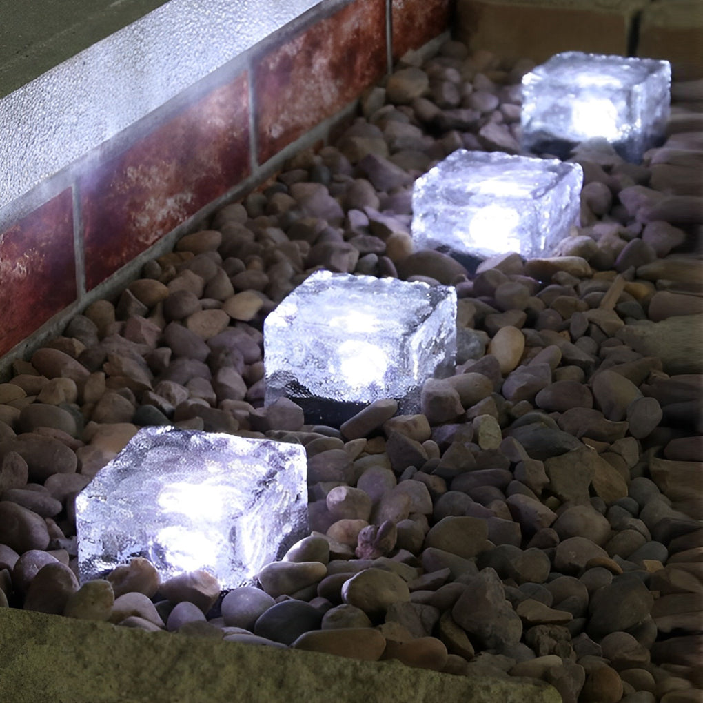 Cool white ice cube solar lights installed along an outdoor wall edge.