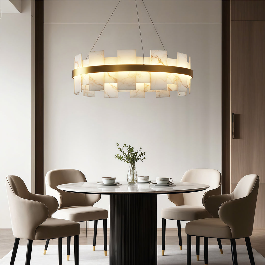 Modern luxury chandeliers above round dining table in sophisticated neutral interior