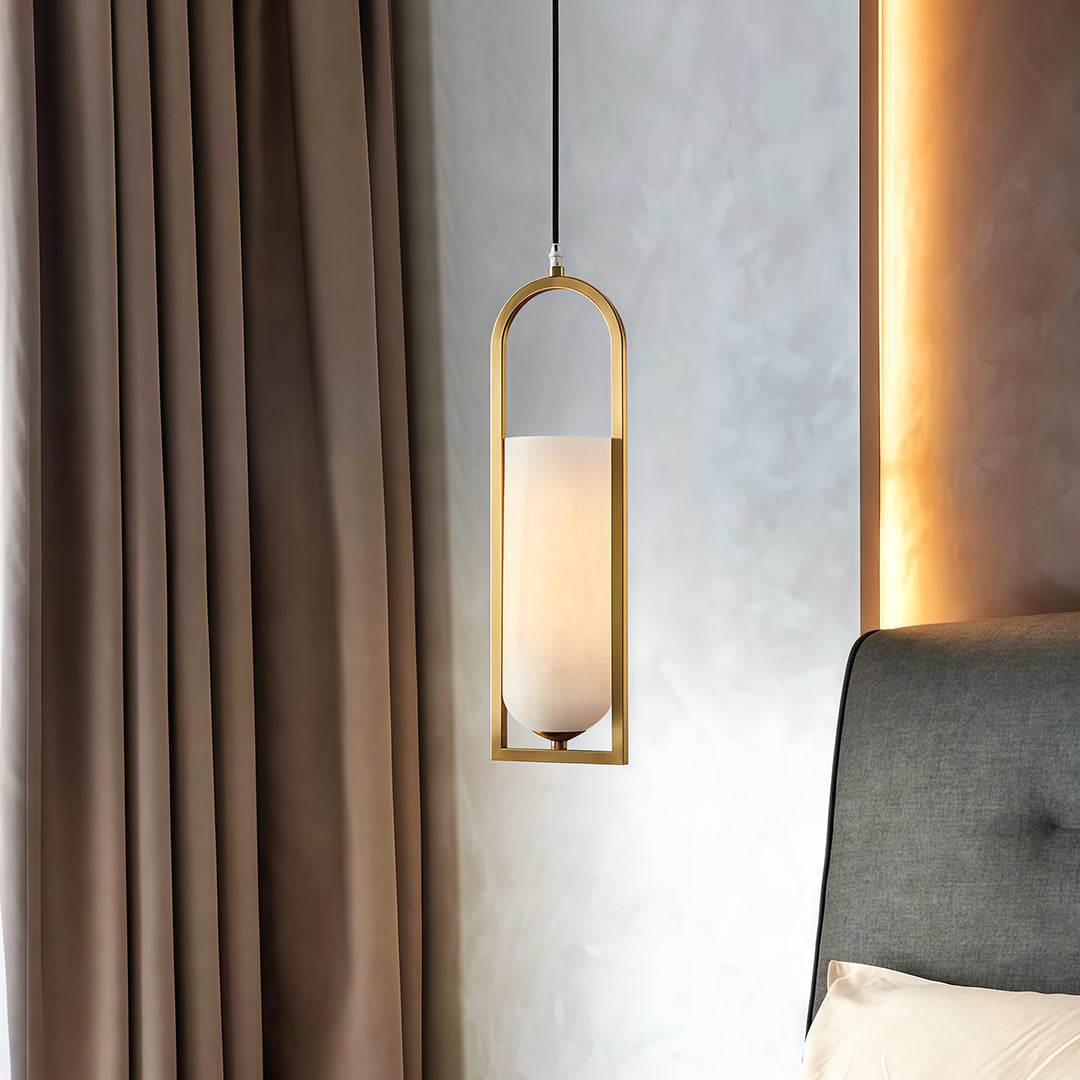 Copper hanging pendant lights installed near window providing warm ambient lighting in residential interior