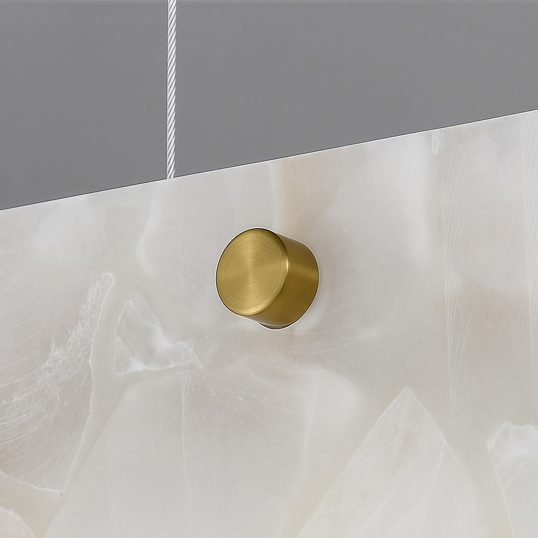 Copper metal pendant light with a circular gold detail, emphasizing modern and luxurious design.