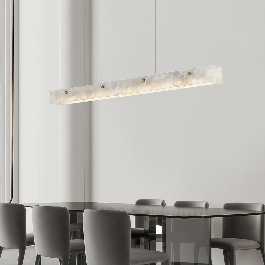 Copper metal pendant light with a marble detail, enhancing the ambiance of a sophisticated dining space.