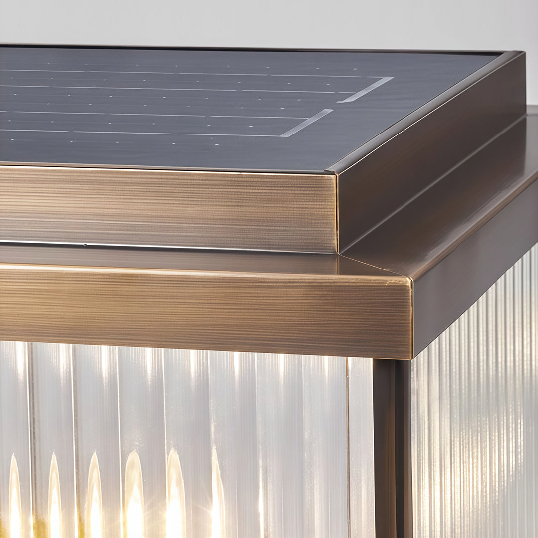 Detail shot of copper pillar light corner revealing layered construction and warm wooden base trim.