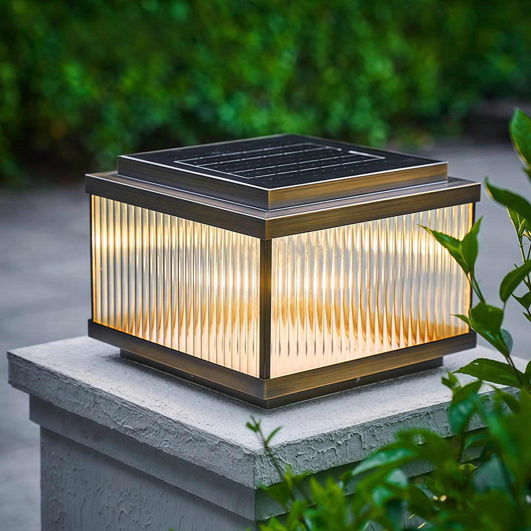 Copper pillar lights installed on stone column base creating elegant outdoor pathway illumination.