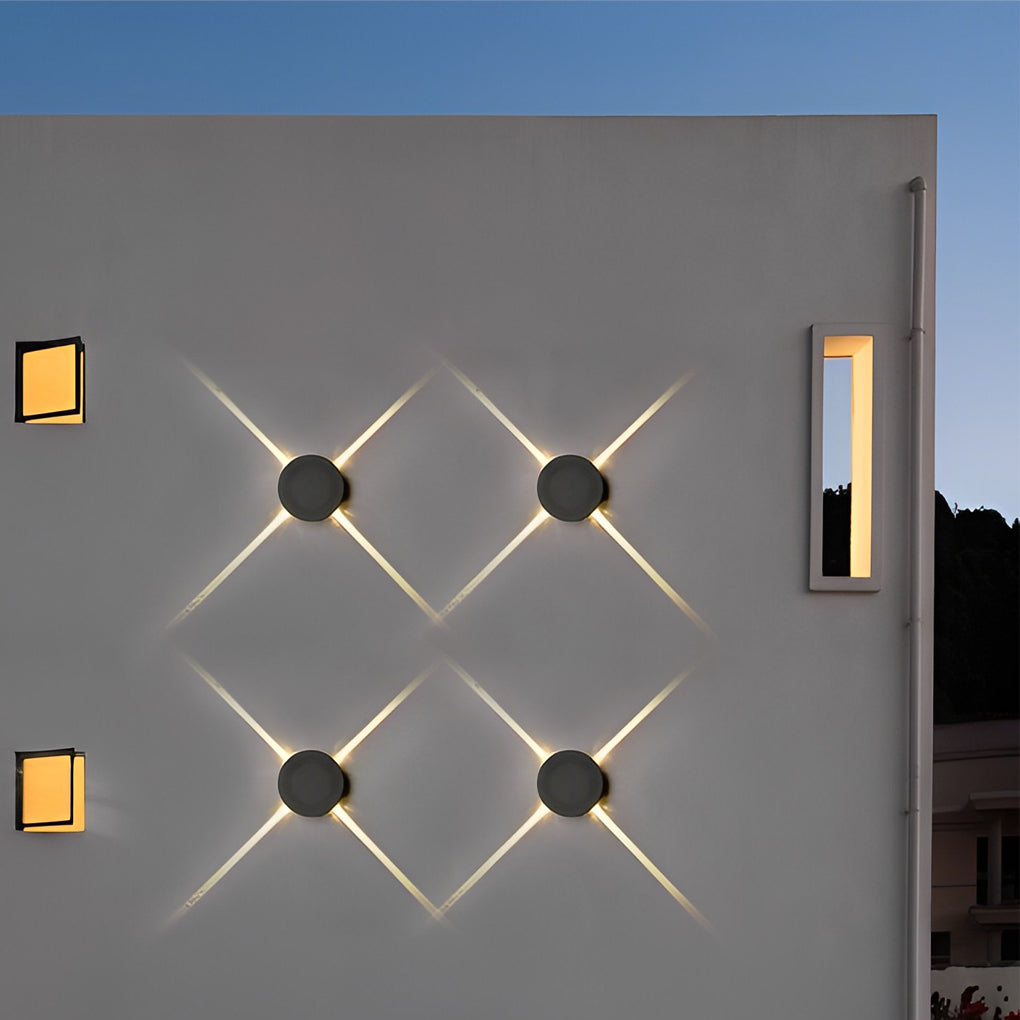 Cross light beams wall sconce illuminating a contemporary outdoor space with ambient light.