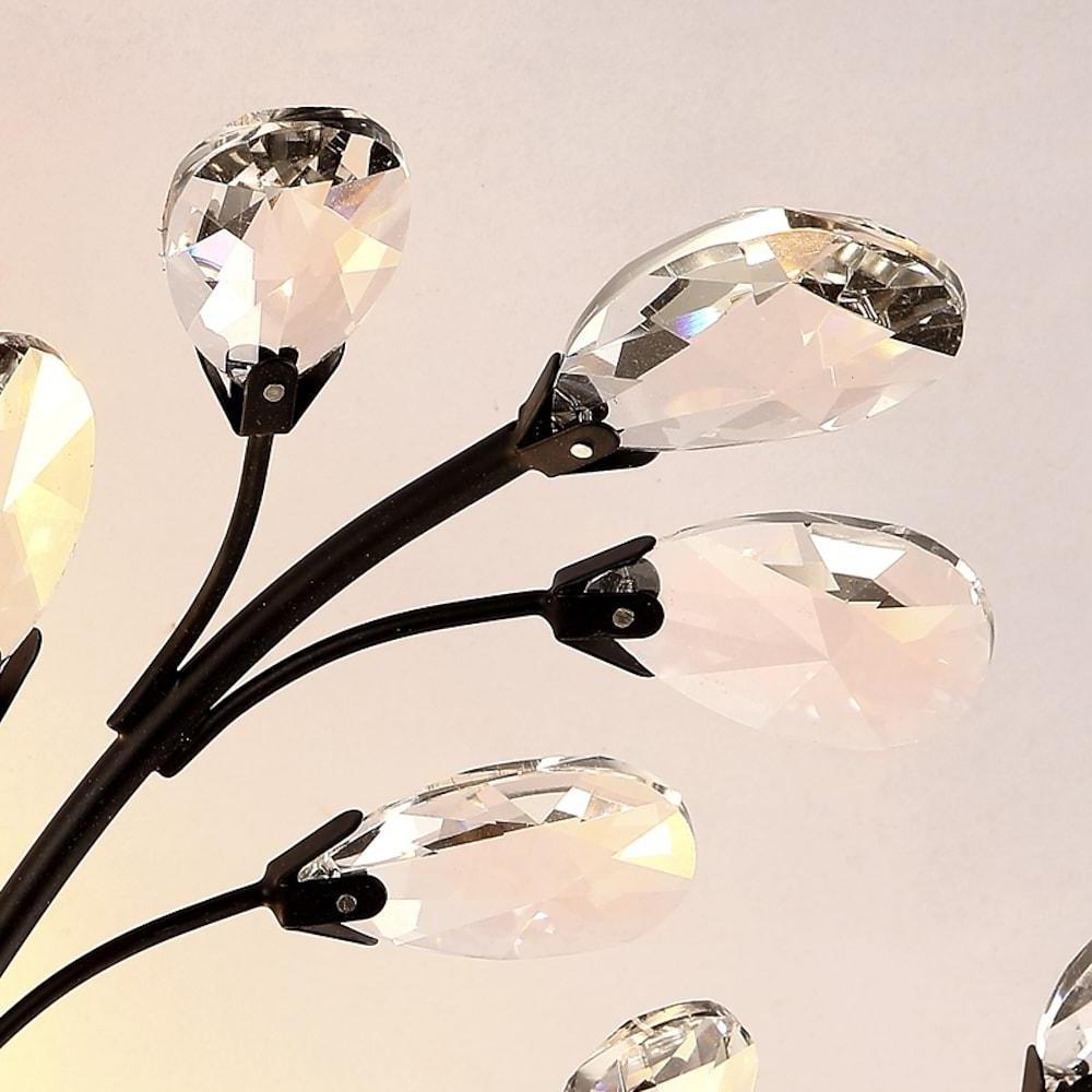 Close-up of crystal branch chandelier showing crystal leaf details.