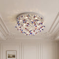 Elegant crystal flush mount lights with vibrant red and blue floral crystals on a chrome base.