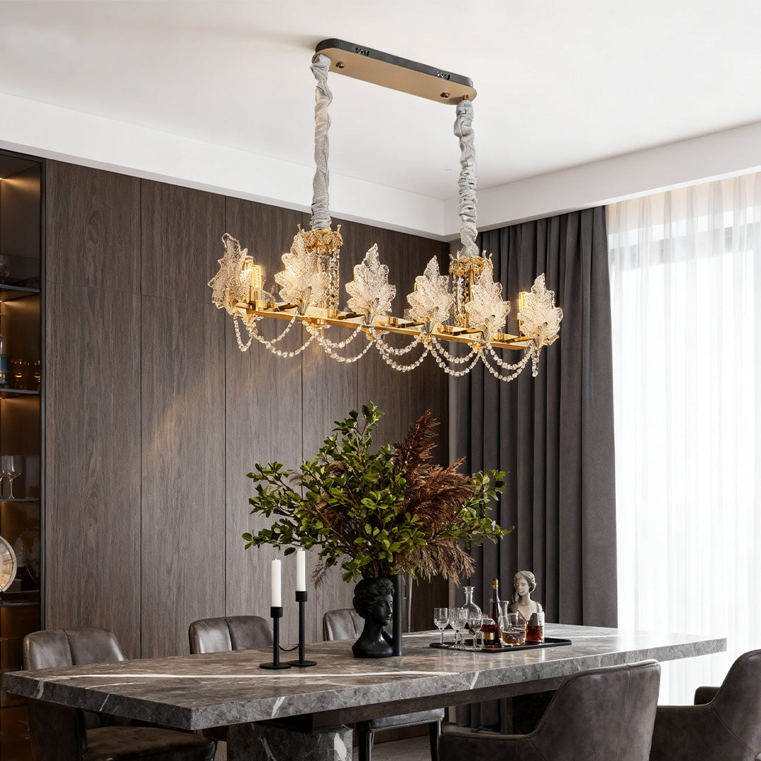 Crystal French chandelier illuminating a modern dining table setting.