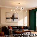 Crystal vintage chandelier creating focal point in contemporary living room with green accent wall and modern decor