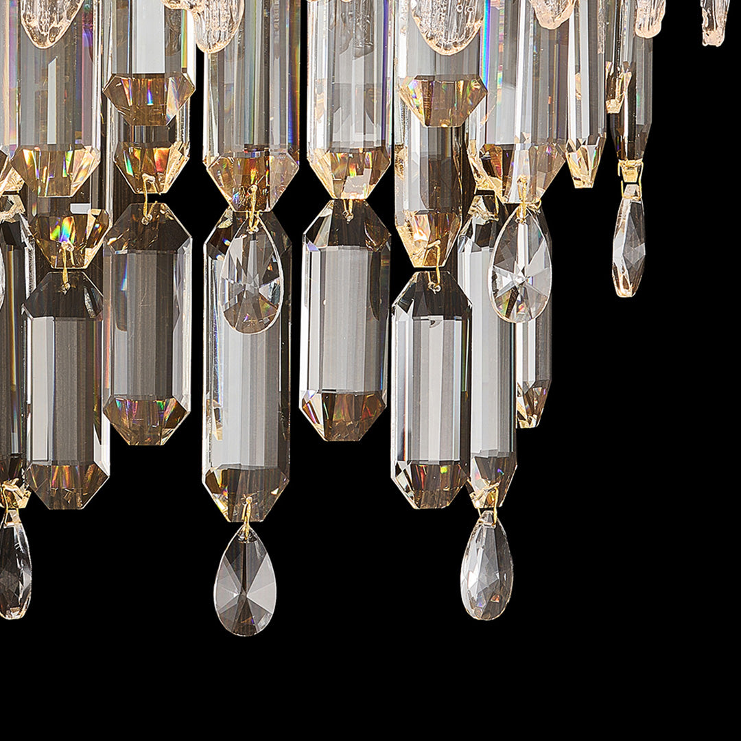 Close-up of crystal wall sconce lighting showing faceted glass prisms and gold metal details.