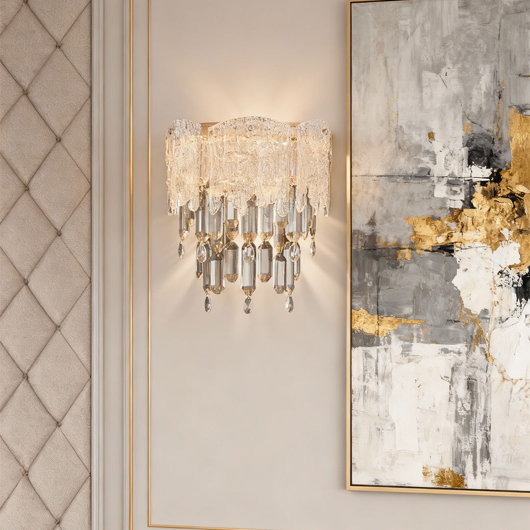 Crystal wall sconce lighting paired with abstract wall art in luxury interior.