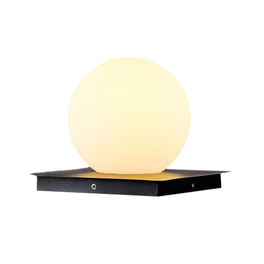 Silver Metal Table Lamp cube and sphere pillar lights with warm LED glow on black base platforms for outdoor applications