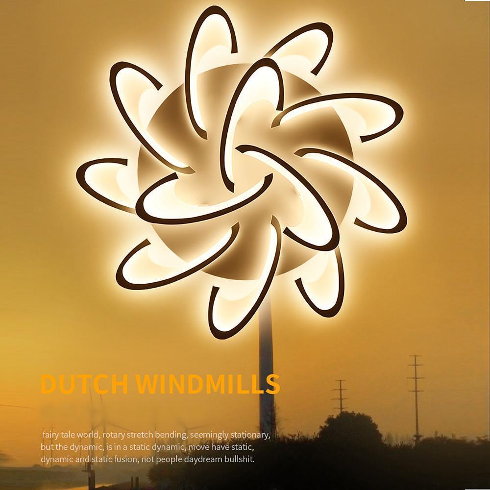 Curved LED ceiling light with floral-inspired swirl design.