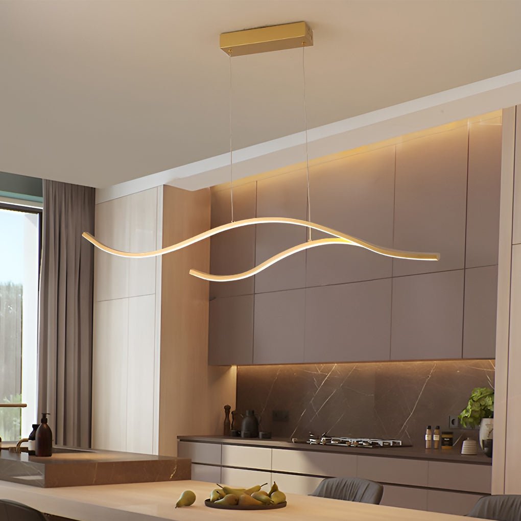 Curved LED pendant light illuminating a modern kitchen island with soft ambient lighting.