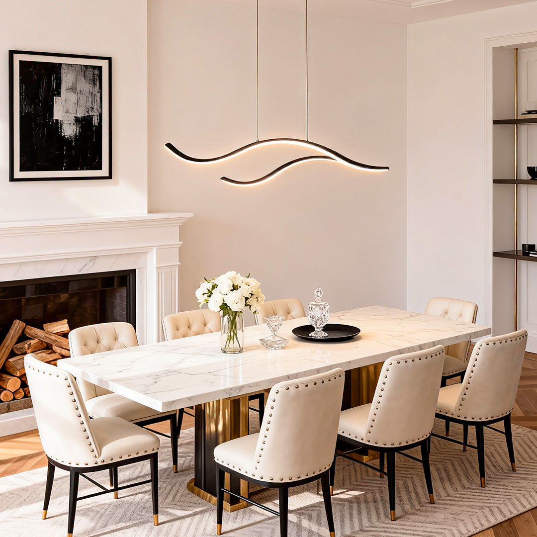Curved LED pendant light over a long dining table in a bright, elegant interior.