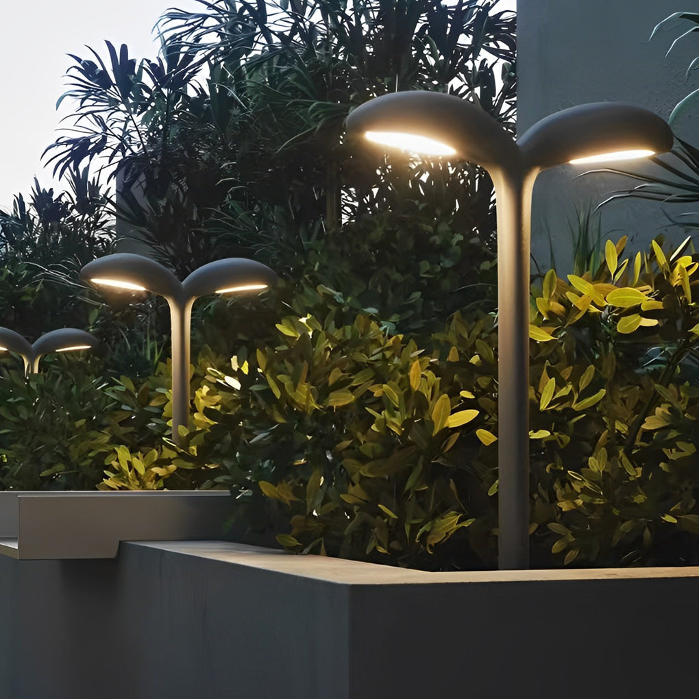 Curved path light providing soft illumination along a stylish outdoor walkway.