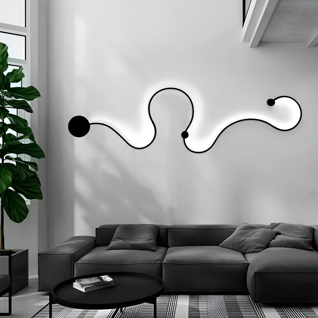 Modern curved wall sconce installed above a sofa as decorative wall lighting.