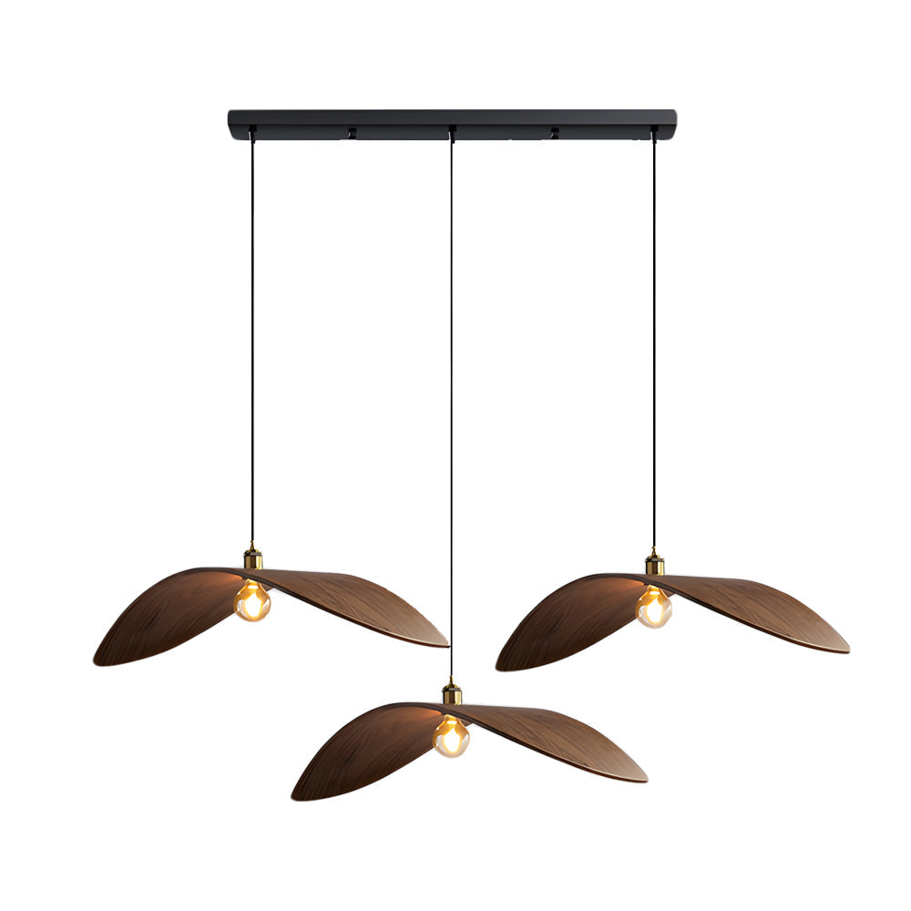 Curved wood pendant light with a brass detail, providing soft illumination in a living space.