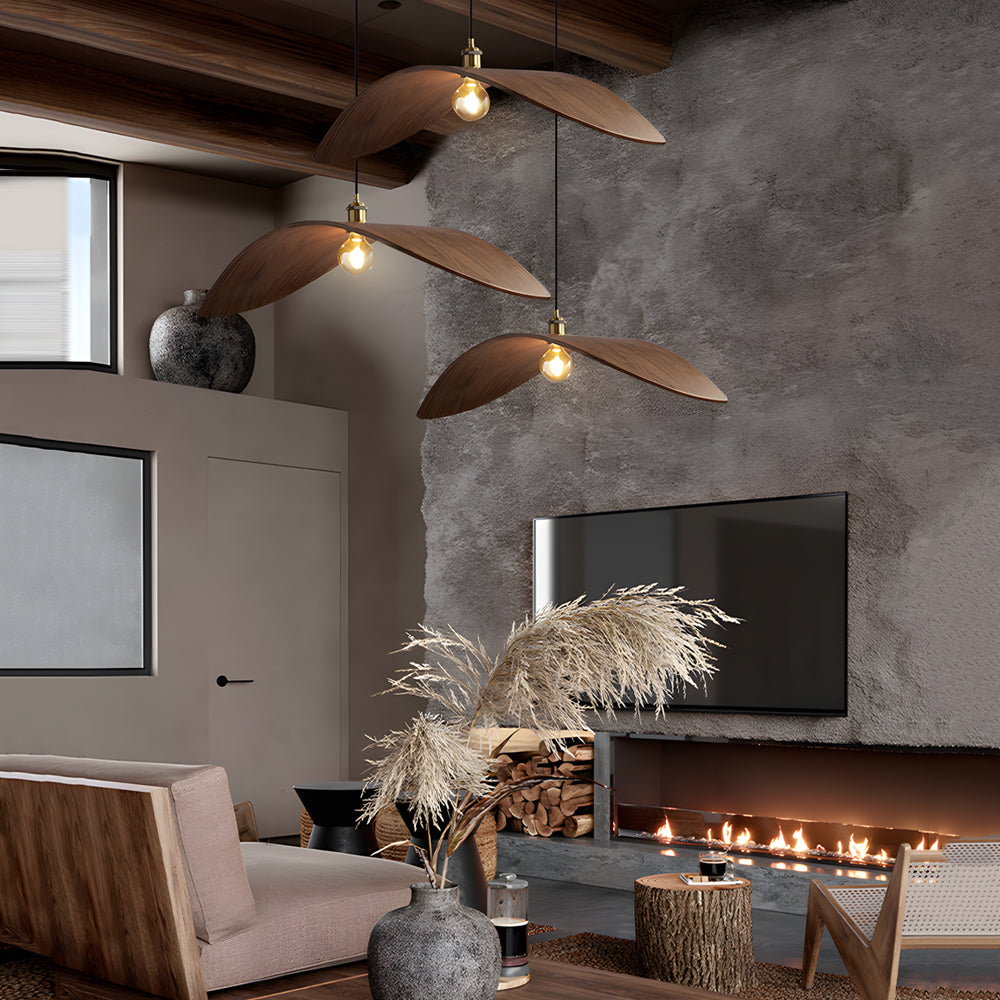 Curved wood pendant light with a natural finish, hanging above a modern dining table.