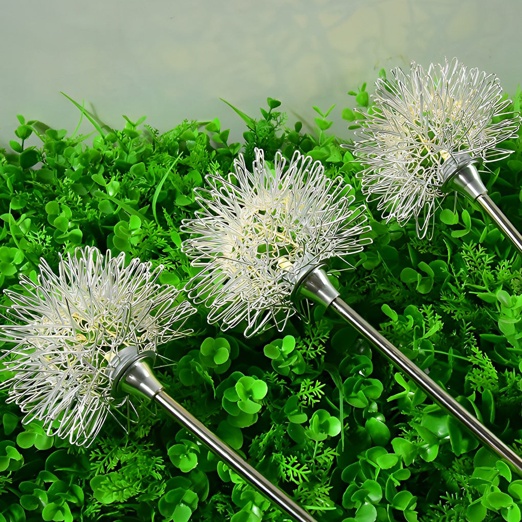 Dandelion landscape lights with a single glowing bulb, highlighting the intricate metalwork design.