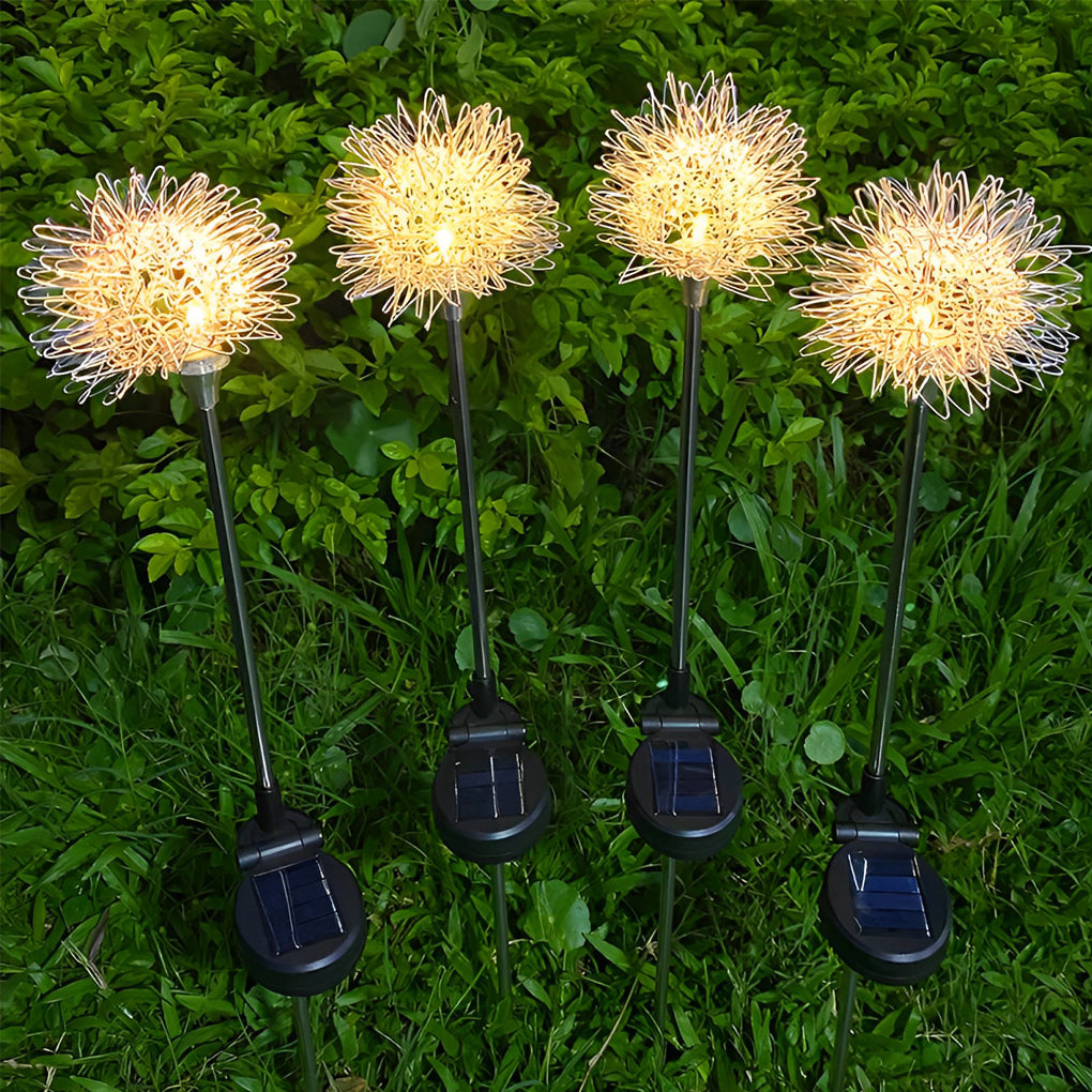 Dandelion landscape lights glowing warmly in a garden, creating a whimsical and inviting atmosphere.