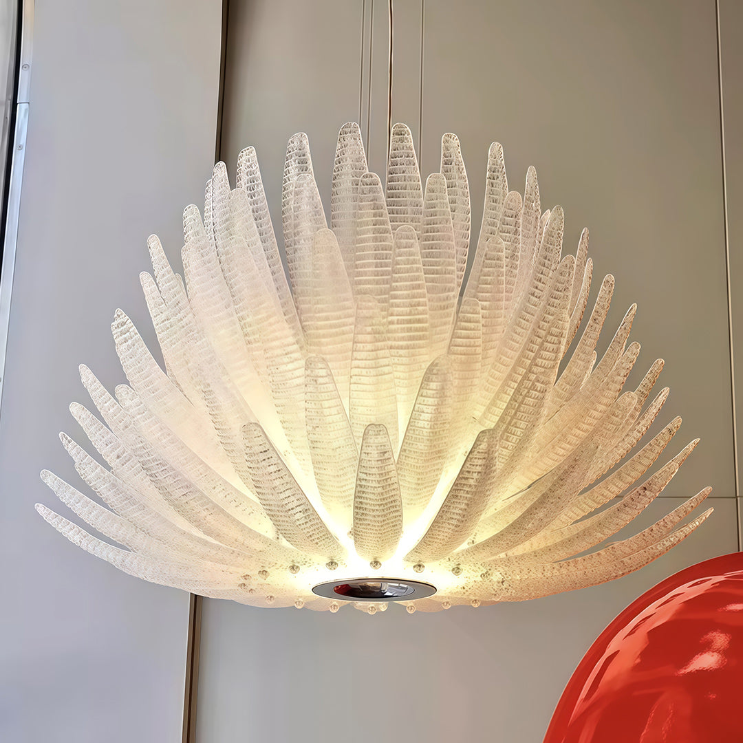 This deco chandelier features a stainless steel frame with glass elements, adding timeless luxury and warm illumination to interiors.