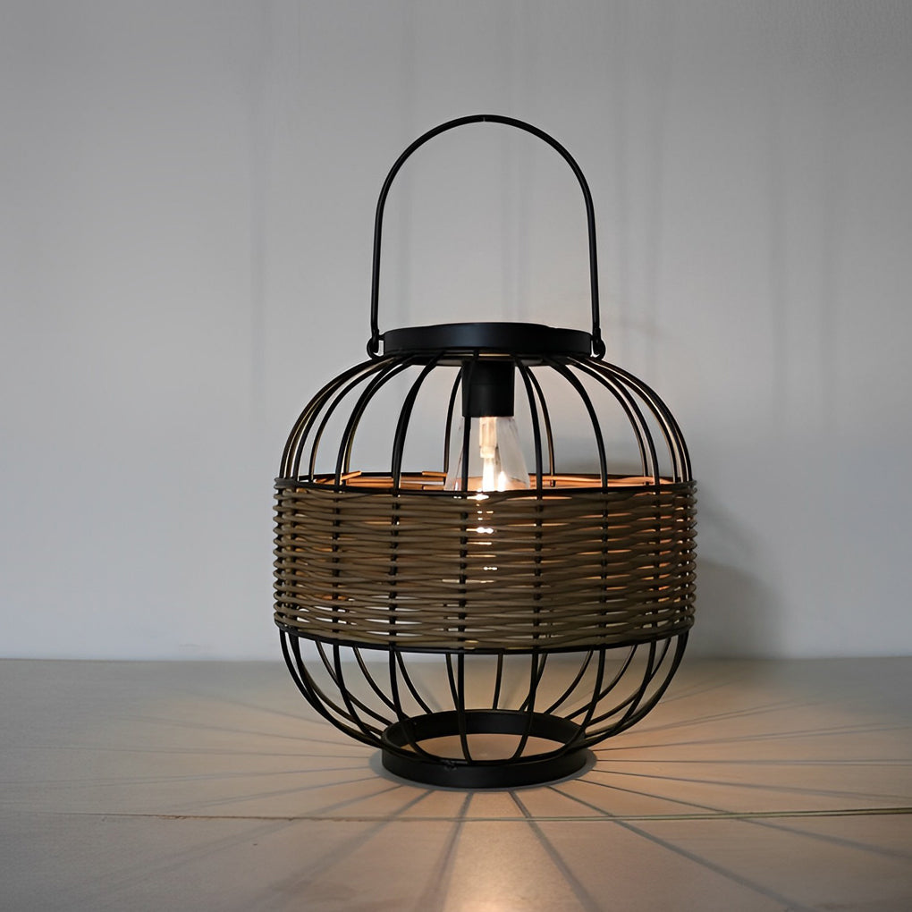 Decorative hanging solar lantern with a black metal frame, glowing warmly on a patio table.