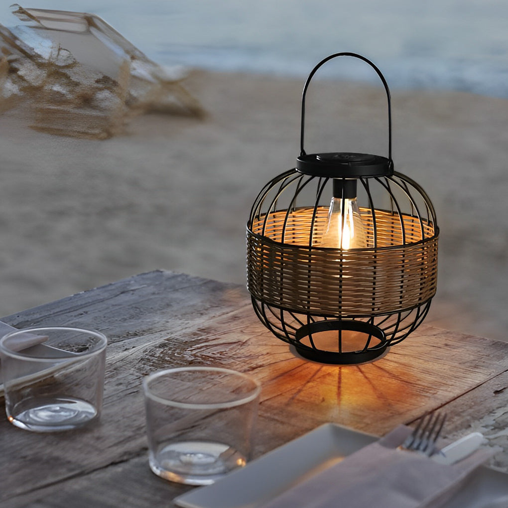 Decorative hanging solar lantern with a woven design, illuminating a beachside table at dusk.