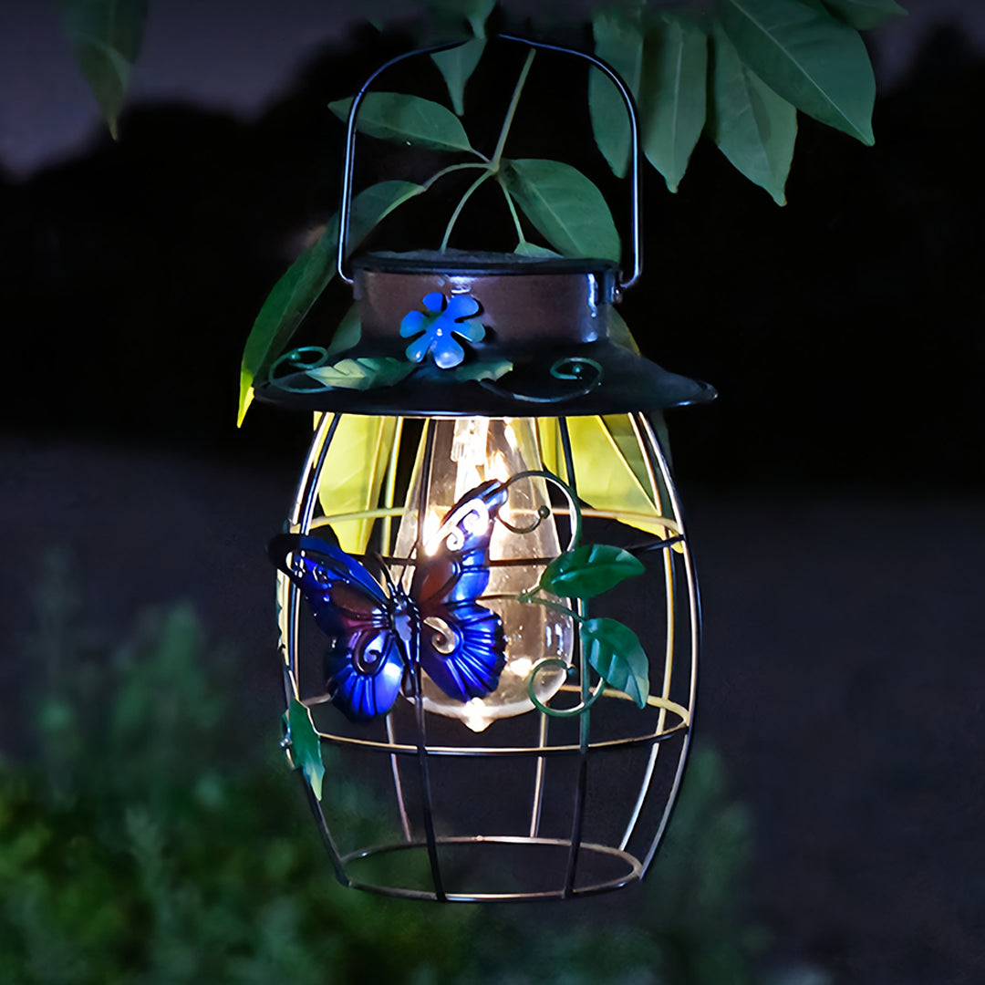 Decorativ metal iron outdoor lanterns illuminating a garden area at night with warm LED light