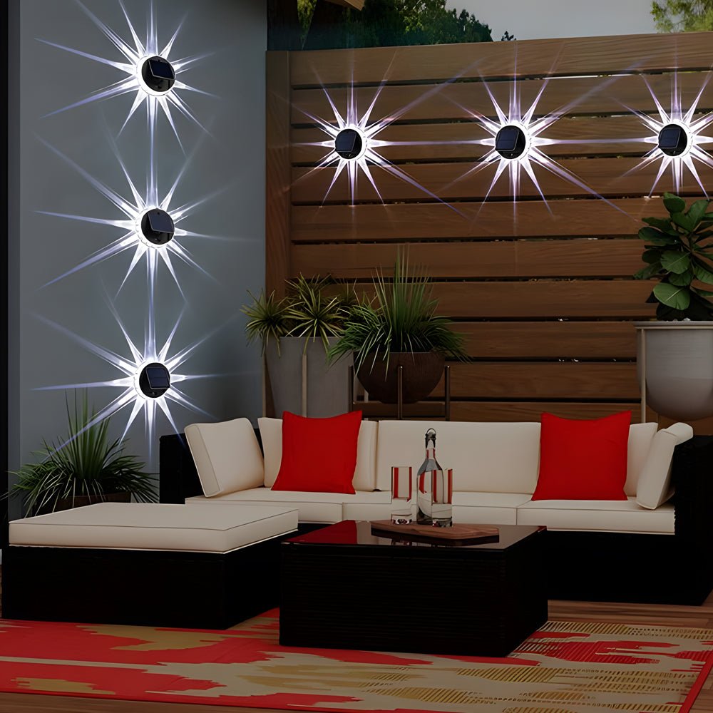 Decorative outdoor patio solar lights creating a starburst effect on a wooden fence, perfect for ambient backyard lighting.